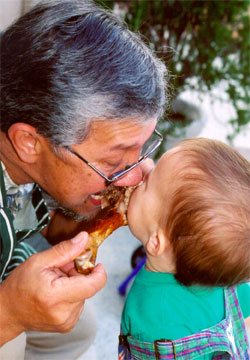 Alex and Papa sharing a bite