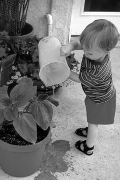 Austin watering his plant