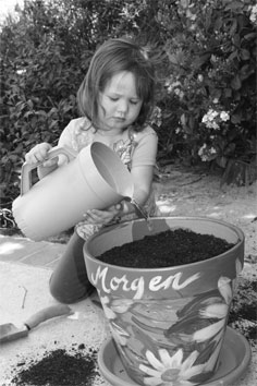 Morgen watering her seeds